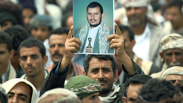 A Yemeni Shiite man holds up a picture of Abd-al-Malik al-Houthi during a demonstration near the capital, Sanaa, in August 2014